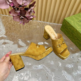 HORSEBIT SLIDE SANDAL IN GOLD MONOGRAM CANVAS AND SHEEPSKIN LINING